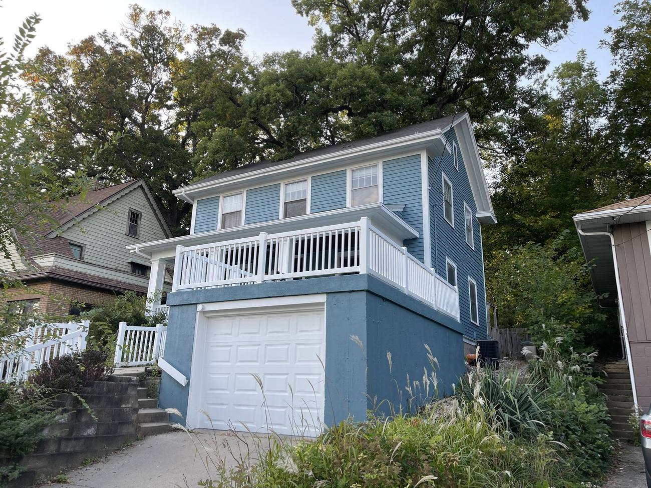 Madison WI home after full exterior repaint by Ask Adam with fresh blue siding and white trim